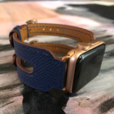 Space Blue Apple Watch Double Buckle Leather Cuff by Juxli Home.  Handmade, stylish leather strap with rose gold hardware on a 40mm Apple watch on a canvas with a black and gray painting.