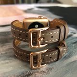 Chocolate Brown Double Buckle Apple Watch Leather Cuff by Juxli Home.  Handmade, stylish leather strap with rose gold hardware on a 40mm Apple watch on a canvas with a black and gray painting.