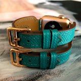 Sea Green Apple Watch Double Buckle Leather Cuff by Juxli Home.  Handmade, stylish leather strap with rose gold hardware on a 40mm Apple watch on a canvas with a black and gray painting.