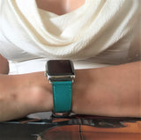 Sea Green Apple Watch Textured Leather Band by Juxli Home.  Handmade, stylish leather strap with rose gold hardware on a 40mm Apple watch on a canvas with a black and gray painting.