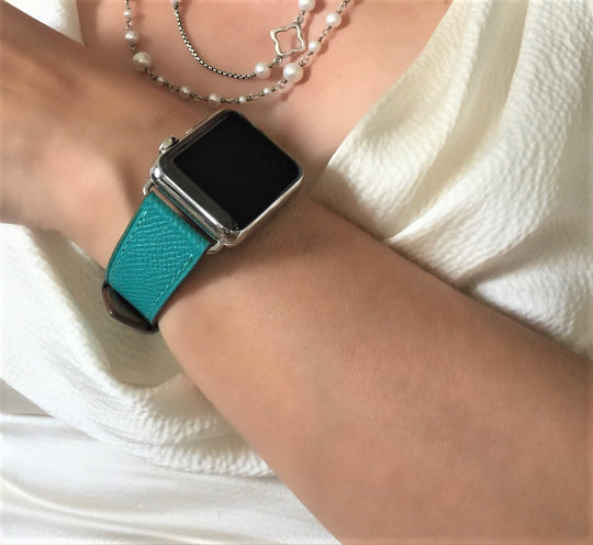 Sea Green Apple Watch Textured Leather Band by Juxli Home.  Handmade, stylish leather strap with rose gold hardware on a 40mm Apple watch on a canvas with a black and gray painting.