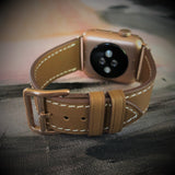 Caramel Brown Apple Watch Leather Band by Juxli Home.  Handmade, stylish leather strap with rose gold hardware on a 40mm Apple watch on a canvas with a black and gray painting.