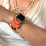 Summer Orange Apple Watch Leather Cuff by Juxli Home.  Handmade, stylish leather strap with rose gold hardware on a 40mm Apple watch on a canvas with a black and gray painting.