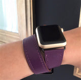 Rasin Purple Double Wrap Apple Watch Leather Band for Women by Juxli Home.  Handmade, stylish leather strap with rose gold hardware on a 40mm Apple watch on a canvas with a black and gray painting.