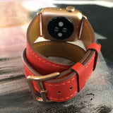 Fire Red Double Wrap Apple Watch Leather Band by Juxli Home.  Handmade, stylish leather strap with rose gold hardware on a 40mm Apple watch on a canvas with a black and gray painting.