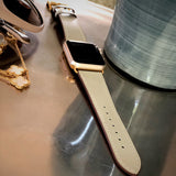 Sage Gray Apple Watch Band by Juxli Home.  Handmade, stylish leather strap with rose gold hardware on a 40mm Apple watch on a canvas with a black and gray painting.